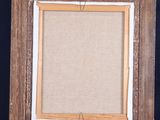 an old wooden easel with an empty canvas on top of it