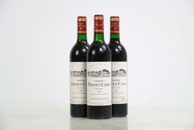 three bottles of red wine sitting on top of a white table