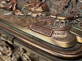 a close up of a bronze statue of a boat on a table