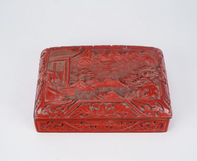 a red box with a design on it sitting on a white surface