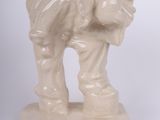 a small statue of a man with a bag on his back