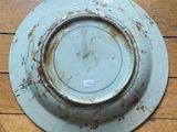 a dirty plate on the floor with a dirty bowl on it