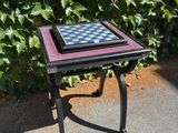 a small table that has a chess board on it
