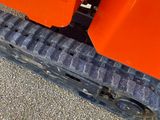 a close up of a tire tread on an orange truck
