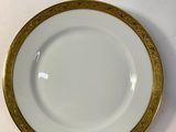 an image of a white plate with gold trim on a white table