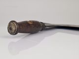 a wooden handle with a metal handle on a white surface