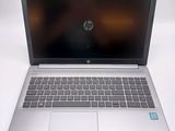 hp laptop computer on a white surface with a blurry background