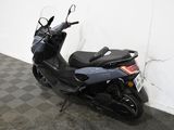 a motorcycle that is parked in a room with a checkered floor