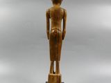 a wooden statue of a woman standing on top of a wooden base
