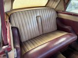 a seat in the back of a car with a window open