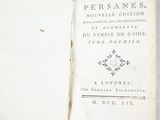 an open book with a black and white cover on a table
