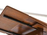 a wooden table with two chairs on top of it