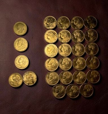 a lot of gold coins sitting on a table