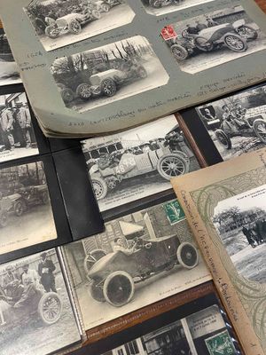 many old photos of old cars on the table