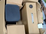 a pile of boxes sitting on the ground next to a car