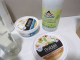 bottles of yogurt, yogurt cream, and a glass of water on a counter