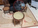 a chair and a table with a mirror on top of it