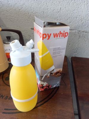a bottle of orange juice next to a box of orange juice on a table
