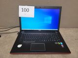a laptop computer sitting on a table with a price tag on it