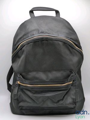 the back of a black backpack with gold zippers on it