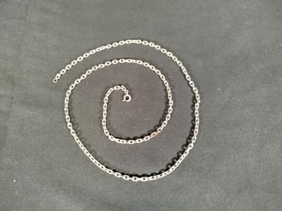 a silver chain that has been placed on a table