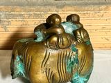 a small statue of a tiger with three babies on it