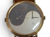 a watch that is sitting on a brown leather strap