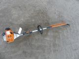 a close up of a string trimmer on a concrete surface