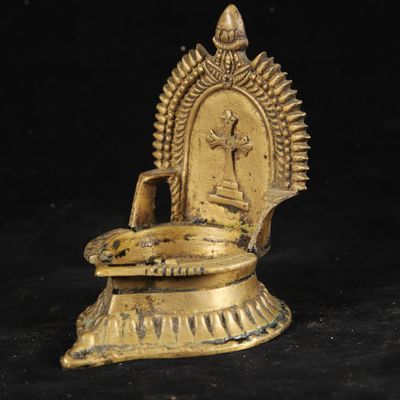 an image of a gold statue sitting on top of a black surface