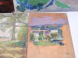 three paintings on a table with one painting on the other
