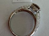 a picture of a diamond ring on a white surface