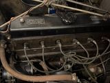 an old car engine with a lot of wires attached to it