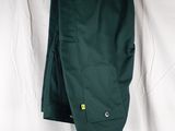the green pants are hanging on a hanger on a white sheet