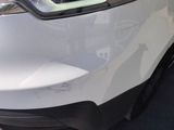 a close up of the front bumper of a white car