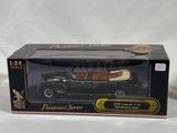 an image of a black toy car in a box on a white background