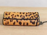 a leopard print wallet purse on a wooden table