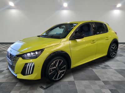 a yellow car parked in a room with a checkered floor