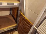 a metal shelf in the corner of a room with shelves