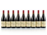 six bottles of red wine lined up in a row