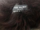 someone is wearing a furry hat with a label on it