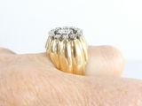 a gold ring with three diamonds on it on a person ' s finger