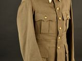 an army uniform on a mannequin stand against a black background