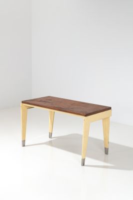 an image of a wooden bench with metal legs in a white room