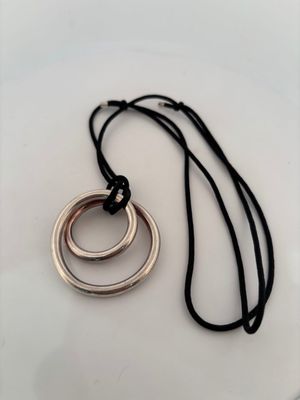 a close up of a necklace with two rings on it