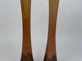 two vases that are sitting on a white surface