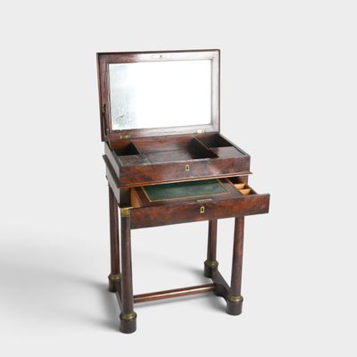 a small wooden desk with a mirror on top of it