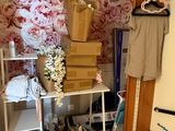 a room with a bunch of boxes and clothes on a shelf