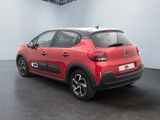 the rear of a red citrole parked in a white room
