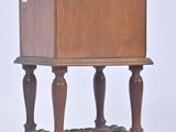 a small wooden table with a drawer on top of it