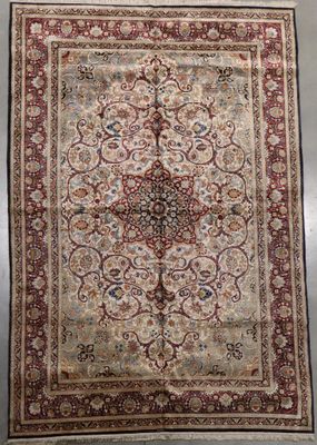 an antique persian rug with a medallion design on a white ground